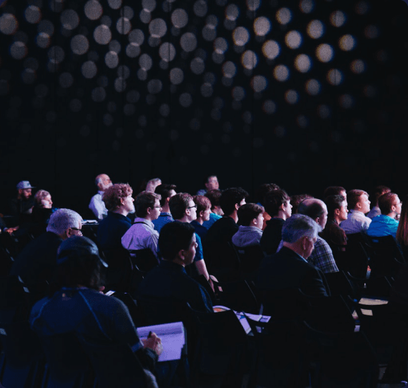 Attendees seated in the audience at an automotive AI conference